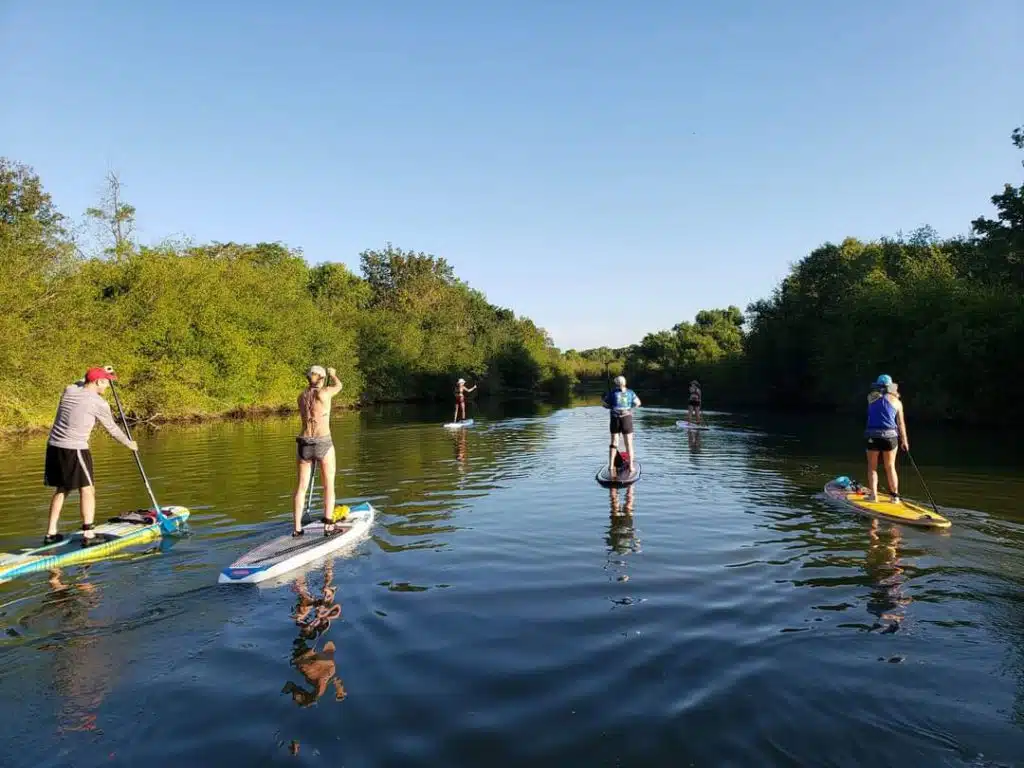 Group paddleboarding on river