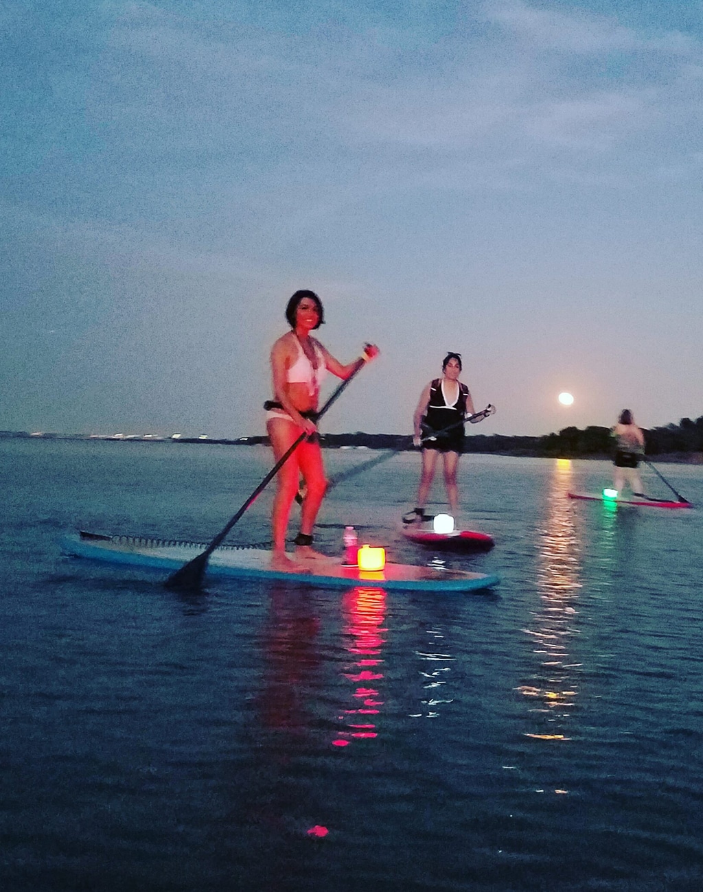 Group paddling on Lewisville Lake during Full Moon Paddle event