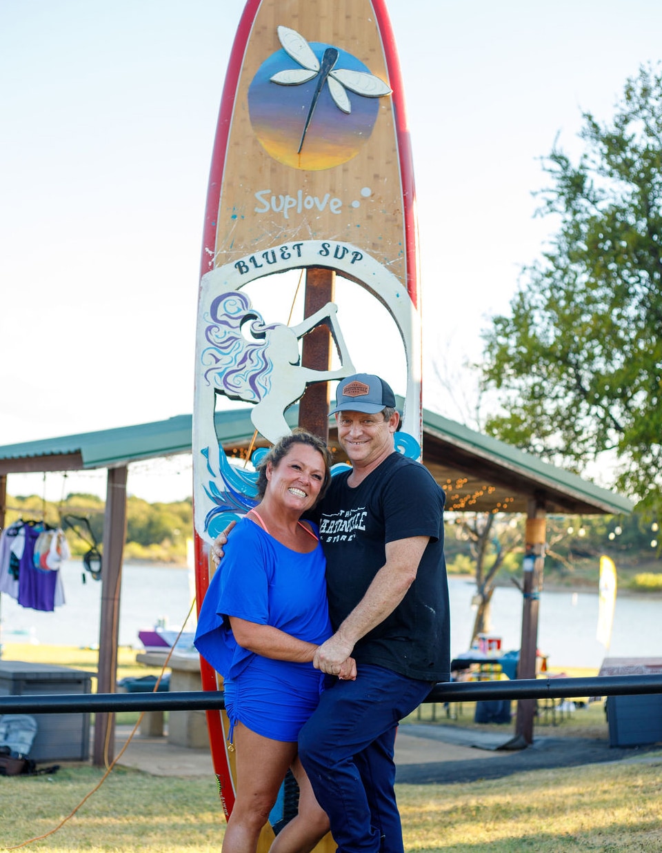 Bluet Sup's owner, Juliet and Chef Michael Scott standing in front of a custom board